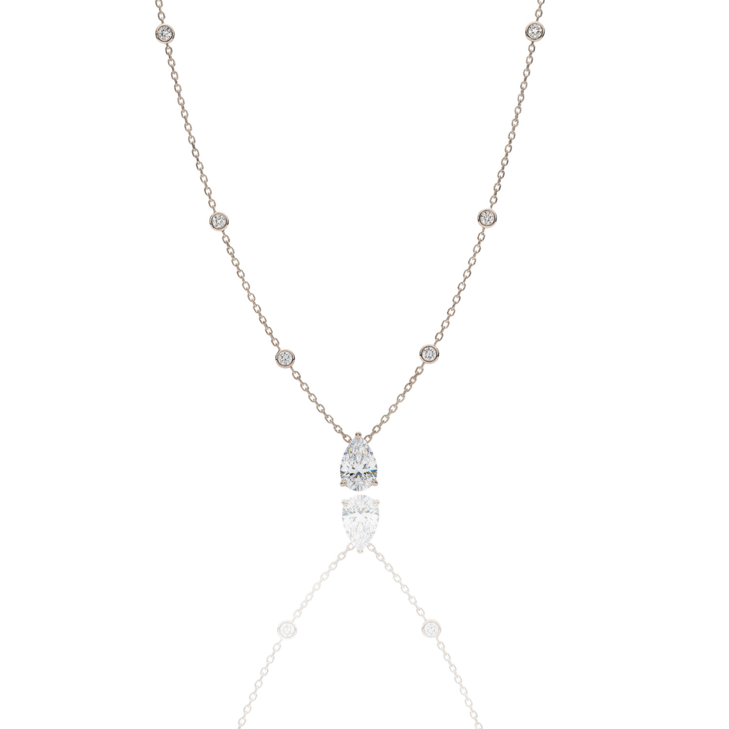 A handcrafted 18kt yellow gold necklace featuring a 1.50 carat G/VS pear-shaped diamond pendant. The delicate gold chain includes 0.40 carats of small, bezel-set diamond accents. Presented by Rebecca’s Diamonds.