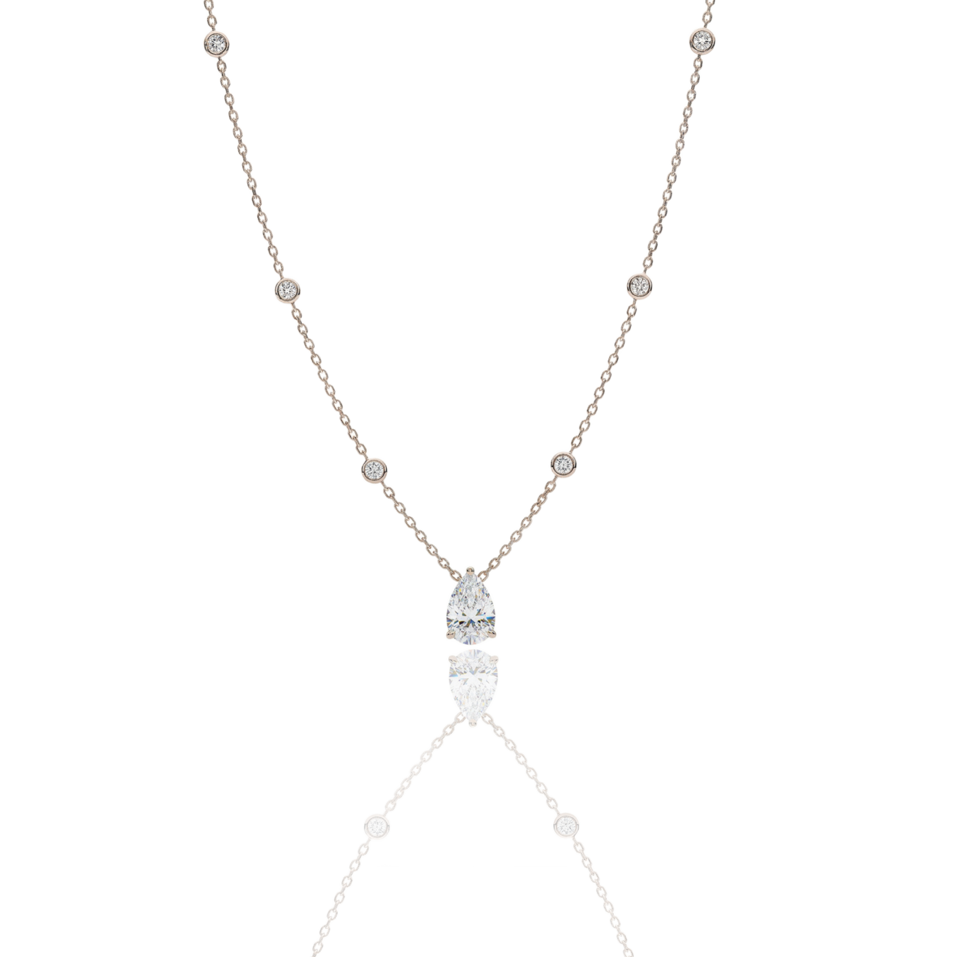 A handcrafted 18kt yellow gold necklace featuring a 1.50 carat G/VS pear-shaped diamond pendant. The delicate gold chain includes 0.40 carats of small, bezel-set diamond accents. Presented by Rebecca’s Diamonds.
