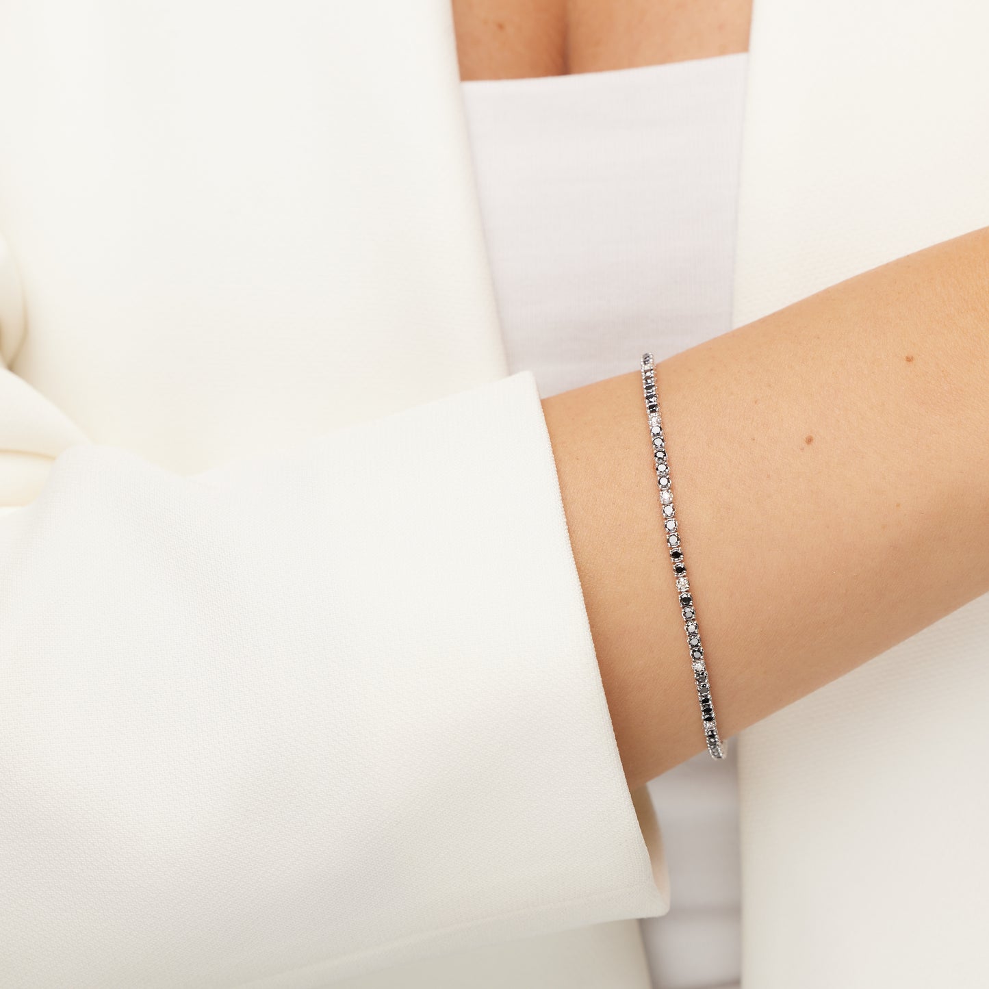 White  gold tennis bracelet with black diamondss and white  diamonds