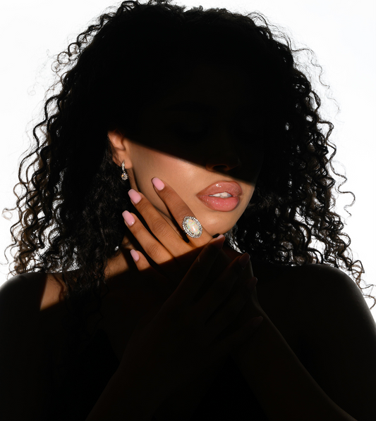 Woman wearing diamond halo drop earrings on ear | Size reference & Styling