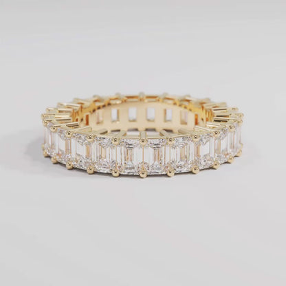 Yellow gold band with emerald cut diamonds